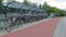 Row of bicycles parked in covered bike rack shelter with a cycle lane