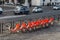 Row of bicycles parked. Orange bicycles stand on a parking for rent. in Rome, Italy