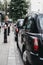 Row of Black cabs parked on a side of the road in City of London, London, UK.