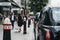 Row of Black cabs parked on a side of the road in City of London, London, UK.