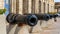 Row of black cannons along the waterfront in Birgu, Malta