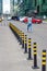 A row of black flexible Parking posts with reflective stripes