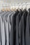 Row of black and grey shirts hanging on coat hanger