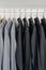 Row of black and grey shirts hanging on coat hanger