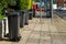 A row of black wheelie bins outside houses in the street ready for rubbish collection