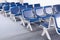 Row of blue chairs in the airport at outbound zone very clean and ordering.