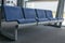Row of blue waiting chairs at the airport