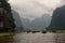 Row boats on a river under cast sky in Vietnam