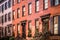 Row of  brick and brownstone New York City apartments seen from outside.