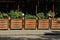 A row of brown square wooden flowerpots