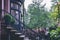 Row of brownstone apartment buildings with steps and tree lined street in Park Slope area of Brooklyn, NY