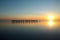 Row of camel silhouettes on beach at sunset in Broome, Western Australia