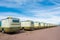 Row of camper vans in sunny weather. A roadside motel of caravans. Sunny