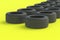 Row of car rubber tyres on yellow background