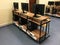 A row of chairs, computers and monitors on the table in the empty classroom