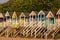 Row of characterful, colourful beach huts on the sea front at Wells-next-the-Sea, North Norfolk UK. Photographed at golden hour.