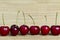 Row of cherries on natural hessian background