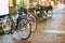 Row Of City Parked Bicycles Bikes In European City.Natural Defocused