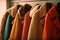 a row of coats hanging on a rack in a room with a coat rack and coat hanger in front of it, and a coat rack with coats hanging on