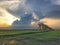 Row of coconut trees On the walk in the rice field at Thai countryside, Beautiful clouds and sunshine With the concept of rural li