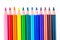 a row of colored pencils sharpened sharply on a white background