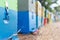 Row of Colorful Bee Hives With Trees in the Background. Bee Hives Next to a Pine Forest in Summer. Honey Beehives in the Me