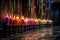 row of colorful candles in a dimly lit space