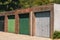 Row of colorful closed garage doors on a sunny day