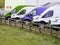 Row of colorful commercial vans in a dealership for sale or rent. Used and new busses. Transport industry. Selection of cargo