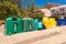 A row of colorful dustbins for waste