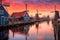 row of colorful dutch windmills at sunset