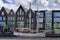 Row of colorful houses on the canals of Haarlem with an old river boat barge in the foreground