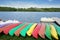 A row of colorful kayaks canoes along a lake of Sidiailles France