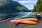 Row of colorful kayaks lying on the shore of Lake Crescent