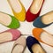 Row of colorful shoes ballerinas on a white wooden background.