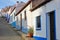 A row of colorful and traditional houses along a steep cobbled street inside Odeceixe near Aljezur, Costa Vicentina, Algarve