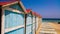 Row of colourful beach cabins near the sea