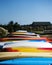 Row of colourful kayaks and paddleboards