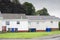 Row of council houses with colour wheelie bins outside