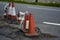 A row of damaged traffic cones