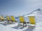 Row of deck chairs overlooking an Alpine peak