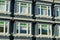 Row of decorative windows on condo or appartment building in the downtown city with blue color and white accent paint