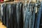 Row of denim pants hanging on trempels