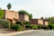 Row of desert style houses and homes in the late evening sunlight with flat roofs in adobe style in arizona