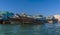 A row of dhow cargo vessels moored on the Dubai Creek in the UAE