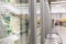 A row of display cases with frozen foods in a supermarket. Fresh vegetables and berries in packages. Vitamins and a healthy diet.