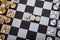 A row of dollar coins in the center of the chess board and chess in a standoff