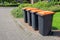 Row of dutch grey waste bins along street