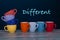 Row of eight different cups of coffee of vibrant colors.