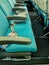 Row of empty airplane seats turquoise color